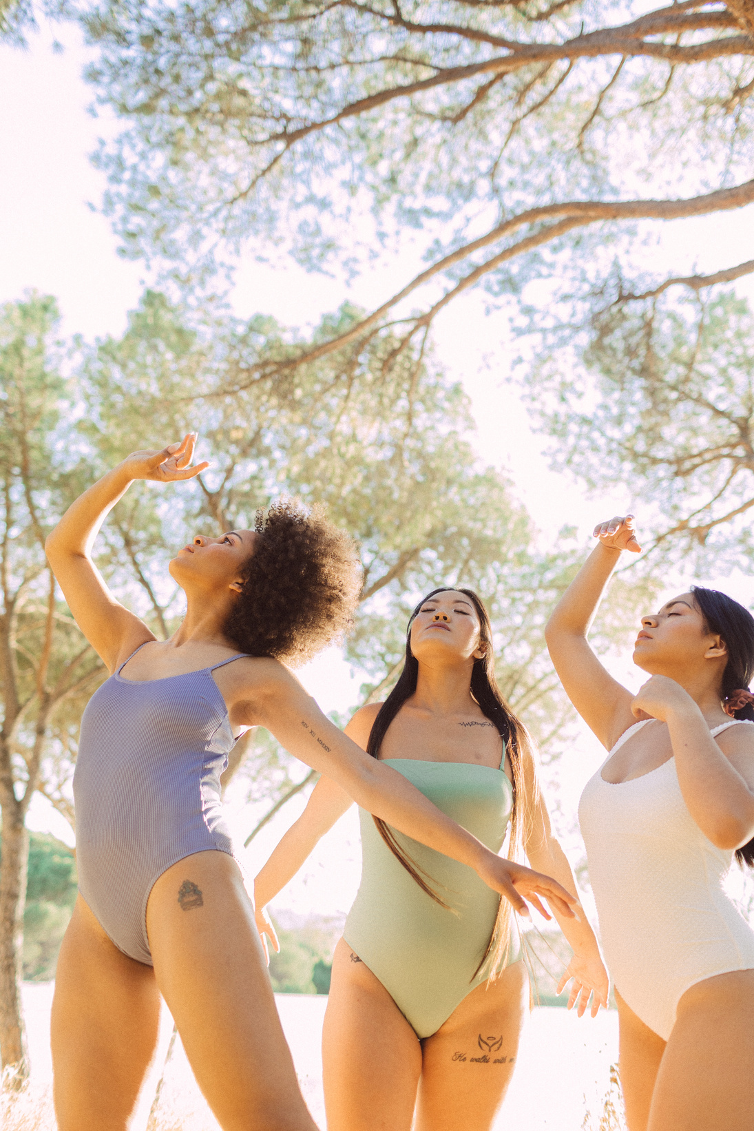 Three Diverse Women in Pastel Swimwear Outdoors